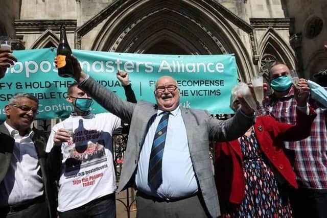 Tom Hedges (centre) outside the Court of Appeal after being vindicated.