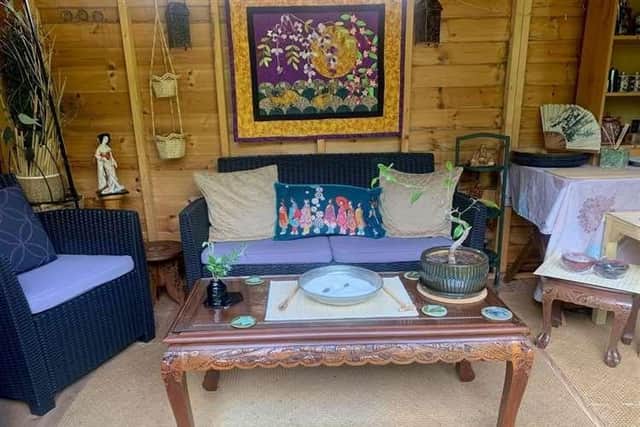 The centrepiece settee and patchwork quilt inside Prisca's garden retreat.