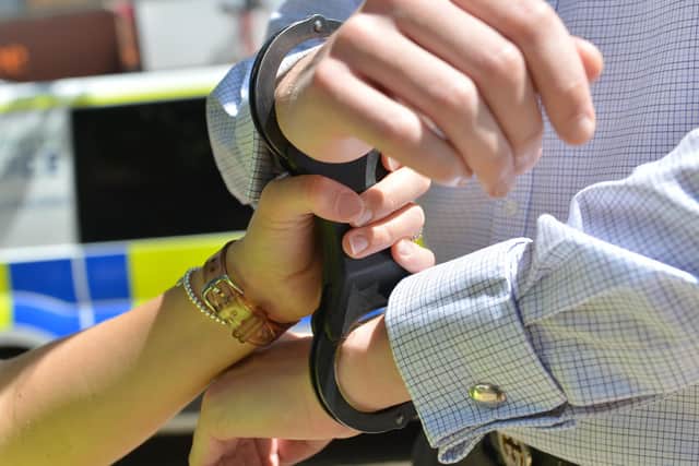 Handcuffs being put on / stock image / arrest