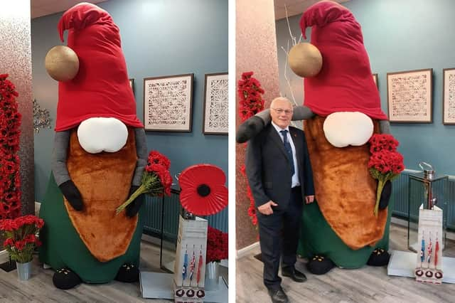 The giant 'gonk' at Cafe Noglish in Boston, and right, Council leader Coun Paul Skinner posing alongside the 9ft creation.