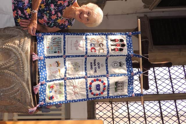 Robbie Mann with the coronation tapestry created by villagers at Silk Willoughby Church.