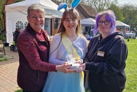 Summer Willetts presents a cheque for more than £1,000 to (from left) assistant manager and volunteer  Maxeen Andrew and manager Naomi Walton.