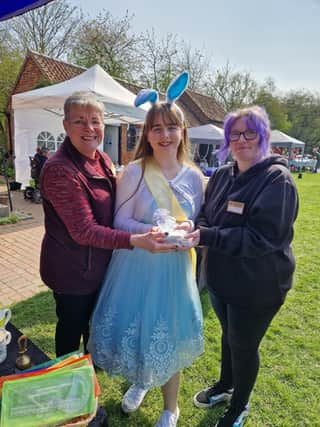 Summer Willetts presents a cheque for more than £1,000 to (from left) assistant manager and volunteer  Maxeen Andrew and manager Naomi Walton.