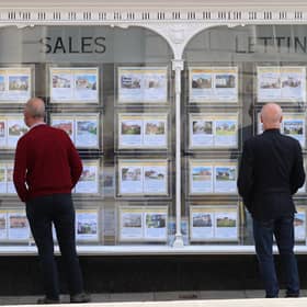 People looking at house price signs displayed in the window of an estate agents in Lewes, East Sussex, as the Office for National Statistics (ONS) has said that the average UK house price has surged by £24,000 during the past year of coronavirus lockdowns. Issue date: Wednesday May 19, 2021.