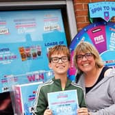 Anna Black wins £100 on the Spar spin game in Sleaford, with son Angus, 12.