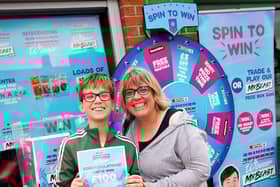 Anna Black wins £100 on the Spar spin game in Sleaford, with son Angus, 12.