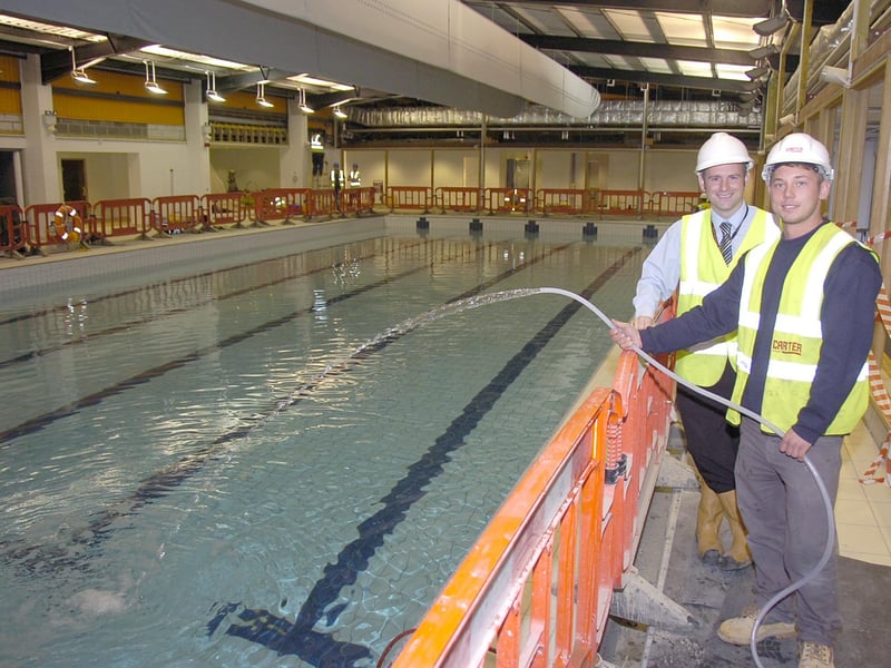 Work on Sleaford's £2.85m leisure centre was drawing to a close 10 years ago. Six days had been spent steadily pouring in 400,000 litres of water into the pool. Principal building survey and project manager Scott Masterman said: "We have had to do this gradually to ensure no damage was caused to the tiles. Now the water is in the temperature will be slowly raised, and the water treated and circulated ready for use.” Pictured with Scott (left) is Martyn Hardy, apprentice site manager.