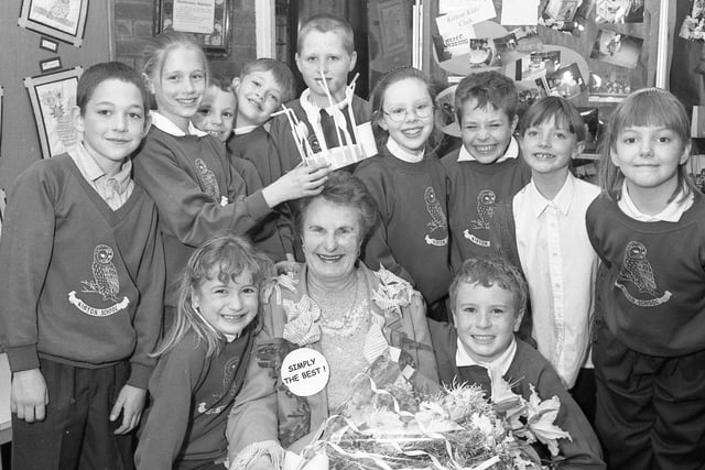 Kirton Primary School bidding a fond farewell to canteen worker Sylvia Hirst as she retired after 30 years' service. She is pictured receiving presents and a crown of cutlery from some of the pupils.