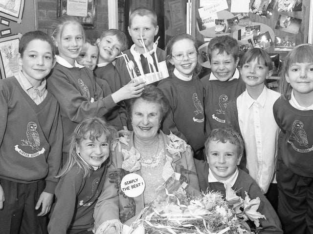 Kirton Primary School bidding a fond farewell to canteen worker Sylvia Hirst as she retired after 30 years' service. She is pictured receiving presents and a crown of cutlery from some of the pupils.