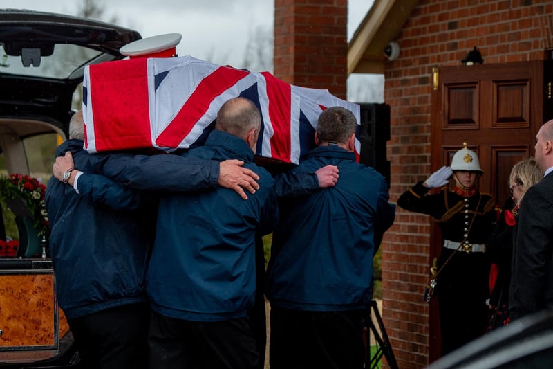 Jack Quinn's coffin is carried into Alford crematorium.
