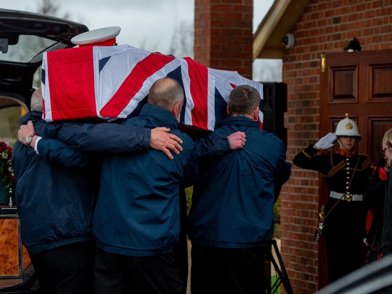Jack Quinn's coffin is carried into Alford crematorium.