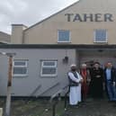 Leader of North Lincolnshire Council, Coun Rob Waltham (far right) and Scunthorpe MP Holly Mumby-Croft (centre) pictured with members of The Bangladesh Welfare Association North Lincolnshire outside the building on Ferry Road that is set to be transformed. Image: North Lincolnshire Council