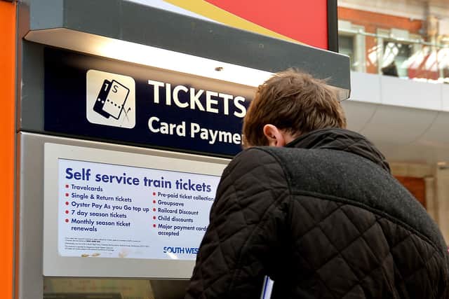 File photo dated 08/12/14 of a train passenger buying a ticket at Waterloo Station in central London, as several train companies are suffering problems accepting card payments for tickets.