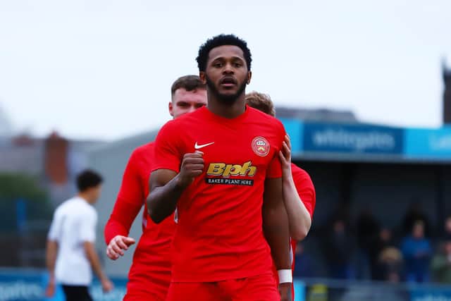 Akeel Francis celebrates scoring.
