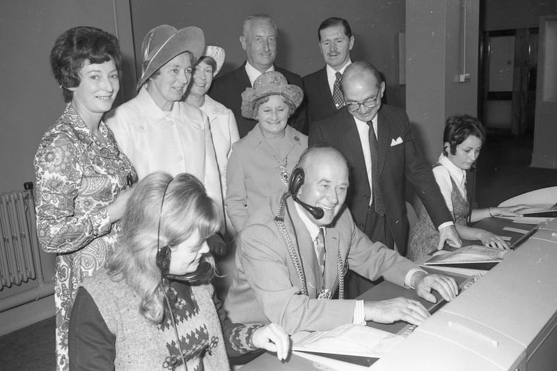 Here, Coun Parker tries out the switchboard, watched by the Mayoress and Mr A. Jones, head of traffic.