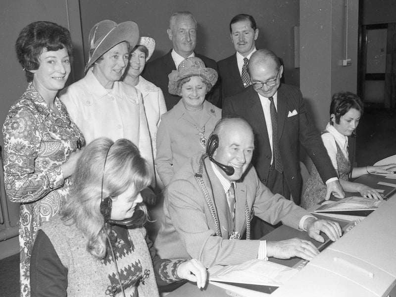 Here, Coun Parker tries out the switchboard, watched by the Mayoress and Mr A. Jones, head of traffic.