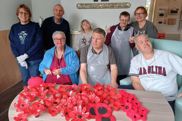 Members of The Old Statin Group with the pile of poppies they have already created. Image: Dianne Tuckett