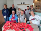 Members of The Old Statin Group with the pile of poppies they have already created. Image: Dianne Tuckett