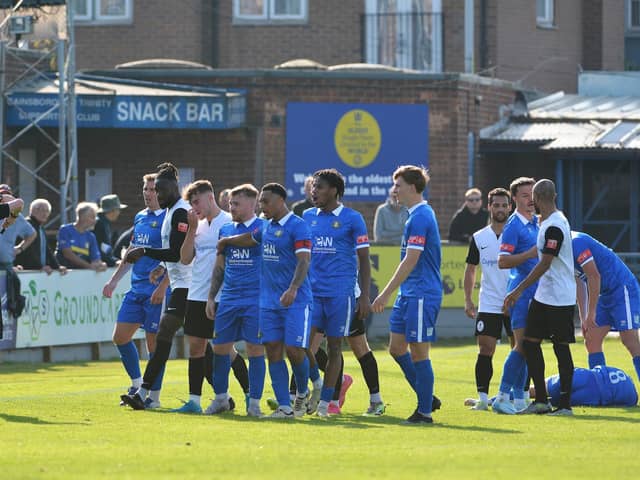 Gainsborough players surround the referee following a bad tackle in Saturday's FA Cup tie. Photo by Mike Sheridan.