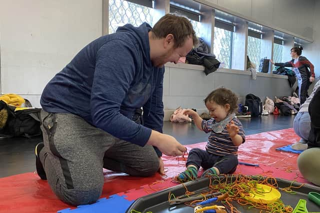 Enjoying the coloured spaghetti.