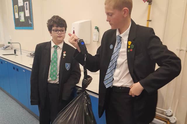 Kayden Wylie and Ethan Gore with some of the recycled paper.