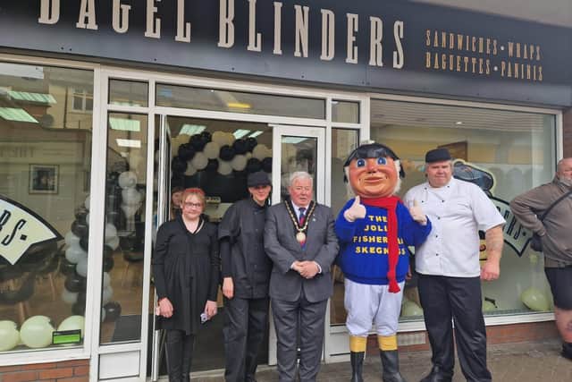 Chris and Stephanie Haynes, owners of the new Bagel Blinders shop in Skegness, with Mayor Coun Pete Barry and the Jolly Fisherman.