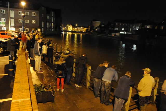 People gathered alongside the banks of the Haven in Boston after a flood warning was issued for the town. Unlike the previous month when the town was hit by major flooding, high tide brought no significant issues.