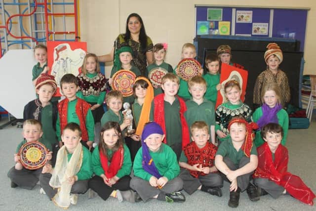 Great Steeping pupils are pictured, 10 years ago, receiving a lesson in Indian culture from Sunita Patel, of The Indian Experience. Children from reception and years one and two enjoyed a range of activities, including dressing in traditional Indian clothing, making Rangoli artwork, and taking part in Indian dancing.