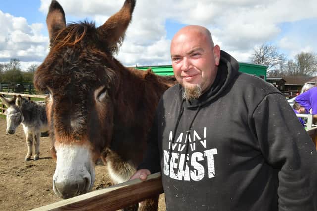 Derrick the donkey with volunteer Ross Clarke at Radcliffe Donkey Sanctuary in HGuttoft..