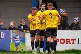 Trinity celebrate scoring at Lancaster. Photo by Michael Porter.