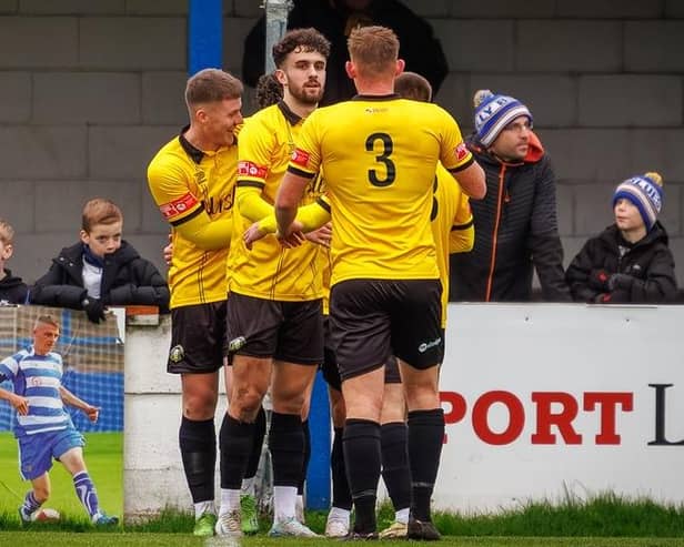 Trinity celebrate scoring at Lancaster. Photo by Michael Porter.