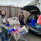The larder's Isabel Forrester loads the donations from Tesco's with manager Jess Smith.