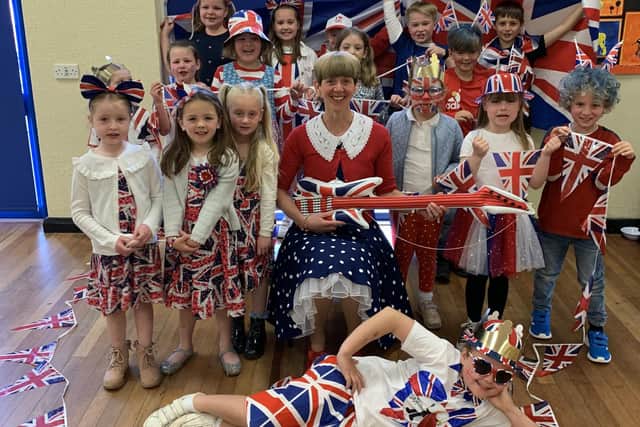 Winchelsea School pupils dressed in red, white and blue for the day, pictured with headteacher Helen Duckett.