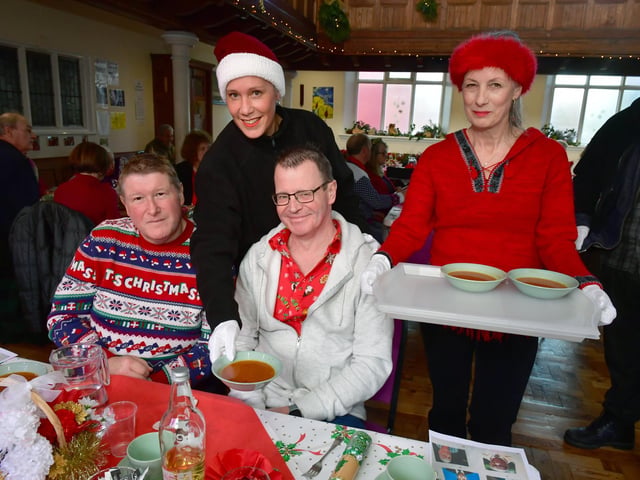 Mark and Derek Beadman-Newitt being served food by (from left) Leah Donovan and Deborah Bartholomew