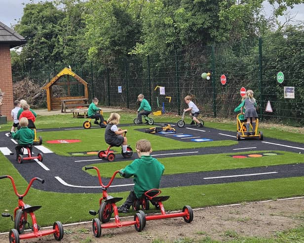 ​Children busily at play in the new outdoor area at Pointon.