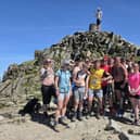 On top of the world - Sean Booth, pictured with his team,  after climbing  the three highest peaks in the UK on one leg  - in just three days.