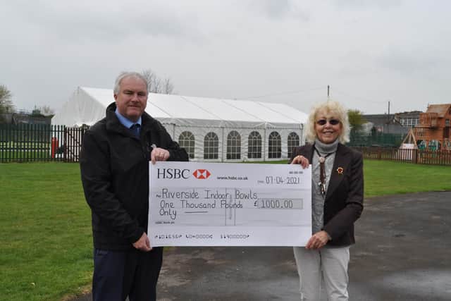 Coun Trevor Young presents a cheque to RIB trustee Linda Grocock
