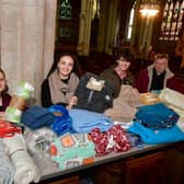 St George's Academy students giving out free blankets and coffee at St Deny's Church on Saturday. From left - Jessica Annan 18, Ranya Tran 18, Ellis Jackson 17, with Rev Philip Johnson.