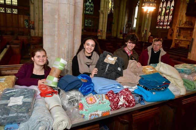 St George's Academy students giving out free blankets and coffee at St Deny's Church on Saturday. From left - Jessica Annan 18, Ranya Tran 18, Ellis Jackson 17, with Rev Philip Johnson.