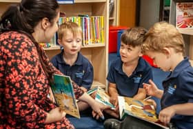 Osbournby pupils reading with their teacher. Photo: CIT Academies