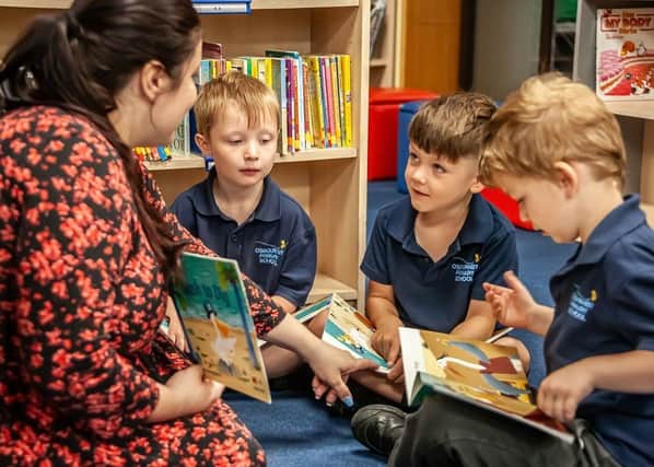 Osbournby pupils reading with their teacher. Photo: CIT Academies