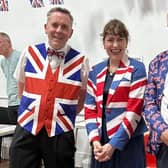 Suitably dressed for the occasion, MP Victoria Atkins celebrates the 80th anniversary of VE Day with a couple of patriotic Horncastle residents.