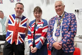 Suitably dressed for the occasion, MP Victoria Atkins celebrates the 80th anniversary of VE Day with a couple of patriotic Horncastle residents.
