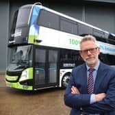 Darren Roe in front of two of Stagecoach East's electric buses