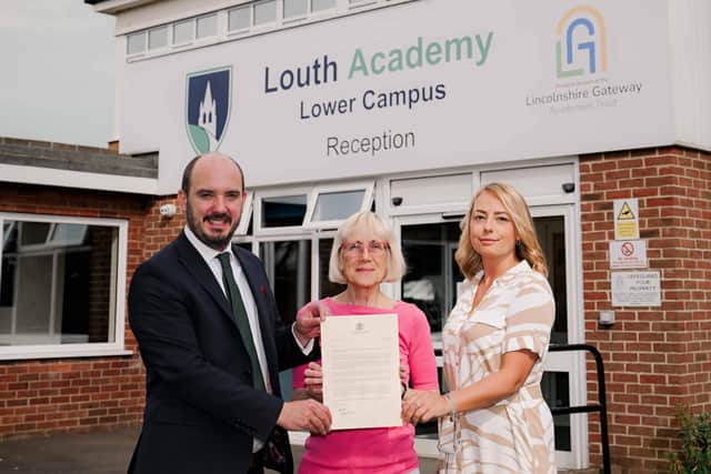 Vice Chair of Lincolnshire Gateway Academies Trust and Louth governor, Jane Aukett, with the letter from the Prime Minister flanked by Principal Joe Hermiston and English teacher Chloe Barker, who will be making a trip to Poland.