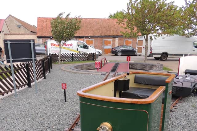 An electric tram car named Stuart, after Stuart Revill of Kirkby Green, whose own light railway inspired Robert, with the railway's turntable beyond.