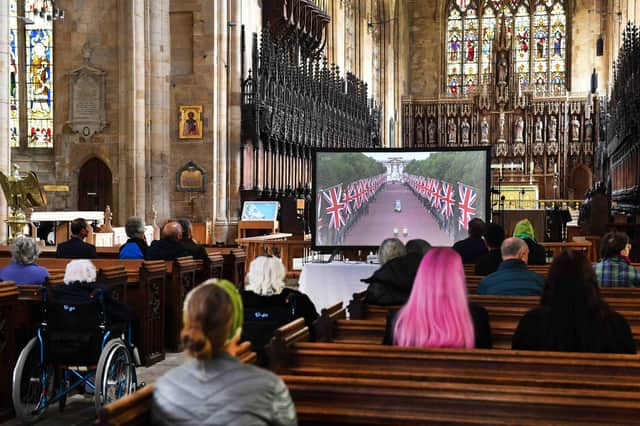 People watching HM the Queen's state funeral as it is screened live from inside Boston Stump on Monday.