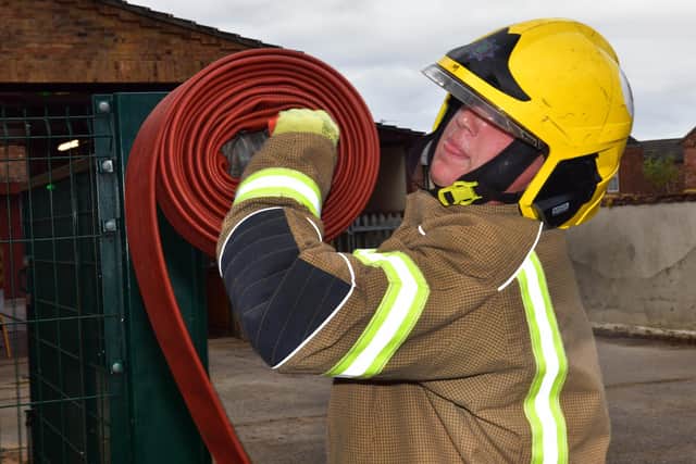 Elliott Wilson trying rolling and unrolling a hose.