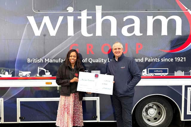 Lorraine Lewis receives the cheque from Nigel R Bottom, managing director of Witham Group.