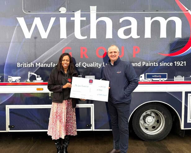 Lorraine Lewis receives the cheque from Nigel R Bottom, managing director of Witham Group.